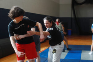 Nguyen gives high-school Summer Enrichment Program participants pointers during her jiu-jitsu class. The enrichment session was one of several workshops, field trips and activities that rounded out participants' days. Photo by K Pearlman Photography.