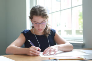 Maeve Scripps, a rising sophomore at the Academy of Technology and Innovation at UMW, works on a project for the Art of Mathematics. The course was one of more than 20 offered to participating high schoolers during the Summer Enrichment Program. Photo by K Pearlman Photography.