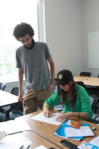 UMW junior Chanse Walker chats with a Summer Enrichment Program participant. Walker was able to take part in SEP, assisting students in Professor of Mathematics Debra Hydorn's course, thanks to UMW's Noyce Scholars Program for students who hope to teach in STEM-related fields. Photo by K Pearlman Photography.