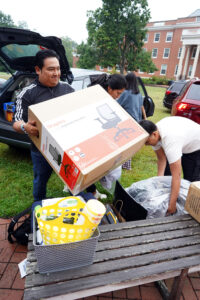 A dad unloads a rolling office chair outside of Randolph Hall during Move-In Day. New students moved into Custis, Randolph, Virginia and Willard halls. Photo by Suzanne Carr Rossi.