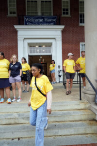 More than 100 students volunteered to help families on Move-In Day. Their bright yellow "I like to move it, move it" T-shirts lit up the day for families who were grateful for their assistance. Photo by Suzanne Carr Rossi.