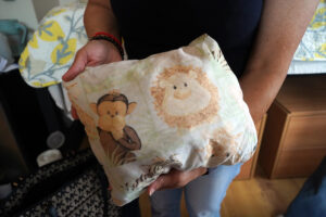 Alexa Lara brought along a pillow that's been on her bed since she was born. Students and their families brought everything from the sentimental to the practical with them on Move-In Day. Photo by Suzanne Carr Rossi.