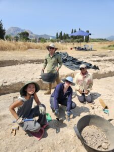 UMW students, including Ava Ward (center, blue hat) at the Lechaion Harbor and Settlement Land Project this summer, working among professional archaeologists to investigate Roman-period workshops, tavernas and basilicas.