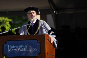 UMW President Troy Paino takes the podium to congratulate soon-to-be graduates at the 2025 Commencement ceremony.