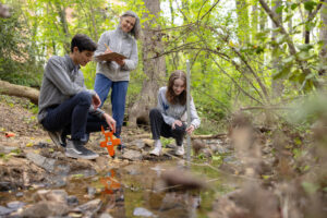 Geography students do hands-on research with a faculty member at the Crow's Nest conservation area. Opportunities to do original research are among the many hands-on learning experiences available to UMW students. Photo by Parker Michels-Boyce