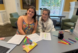 UMW first-year student Lucy Rabung (left) sought the help of her peer mentor, Lauren Spagnuolo, a sophomore, who helped her organize all her syllabi and record the dates of her assignments in a new day planner, provided by LaunchPad.