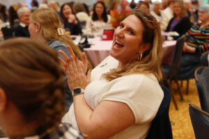 Director of First Year Admissions Sarah Lindberg cheers on her colleagues at the Employee Appreciation Luncheon. Photo by Karen Pearlman.