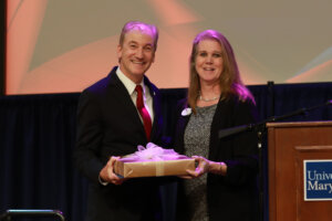 Accounts Payable Manager Lauren Bass (right), who is also president of the University Staff Council, poses with James Monroe Museum Guide Jay Harrison, who received the USC's Larry Atkins Award in the Wage Employee Category. Photo by Karen Pearlman.