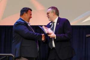 Chief of Staff and Vice President of Strategy Jeff McClurken presents Associate Vice President of Alumni and Donor Engagement Mark Thaden with the Richard V. Hurley and Rosemary A. Hurley Presidential Commendation. Photo by Karen Pearlman.