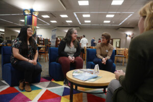 From left to right: Simpson Library Night Circulation Supervisor Sara-Kate Mills, Access Services and Outreach Head Trish Greene, University Archivist Sarah Appleby, and Research and Instruction Librarian Elyse Ridder-Rowe (back to camera) chat during the recent Research and Creativity Collaborative Open House. The space is designed to highlight the University's emphasis on original scholarly work and successful artistic endeavors. Photo by Karen Pearlman.