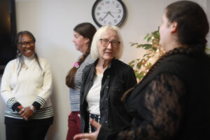 Foreground: Betty Talley (left) chats with Melissa Palguta, a staff counselor in the Talley Center. Background: Glorya Askew (left), a licensed clinical social worker and trainee, and Krysta Thomas, a staff counselor, converse. Photo by K Pearlman Photography.