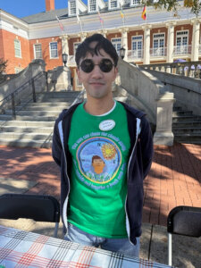 Staff Counselor Jimmy Nguyen passes out information about the Talley Center to students while wearing a T-shirt designed by UMW alum Ty Duenas '16 of Archaic Artisans.