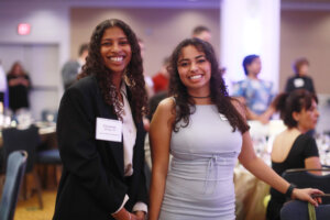 Two college students smiling for the camera.