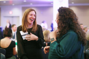 Two guests share a laugh.