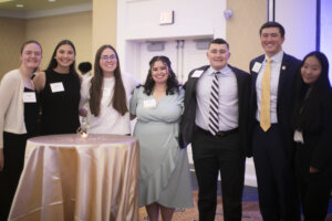 A group of college students in the Student Alumni Ambassador program, along with the group's sponsor, a 2022 alumna.