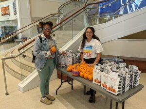 Photo of Mousa, who graduated in the spring and now works as an admissions counselor at UMW, at a campus-wide event that helps classmates access voting.