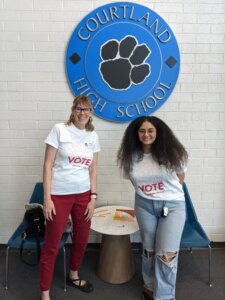 Photo of Director of UMW’s Center for Community Engagement, Sarah Dewees and Merna Mousa ’25 at a local high school to help register high school students to vote.