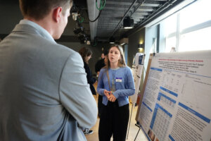Lindsay Smith, a student at Christopher Newport University, answers questions about her research on ageism during a poster presentation at the Network for Undergraduate Research in Virginia Conference, held on Saturday, Nov. 1, at UMW. Photo by Suzanne Carr Rossi.