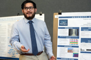 University of Mary Washington computer science major Kaleb Lucas explains his research poster, titled 'Probabilistic Selection Strategies in Asynchronous Jacobi.' Lucas explained the study: 'It's like you’re trying to solve certain things and you know how to do it by hand, but how do you get a computer to do the same thing?' Photo by Suzanne Carr Rossi.