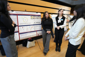 From left: Victoria Pacheco, Alyssa Canelo and Annaliese DeFelice present their research in the Hurley Convergence Center's Digital Auditorium. Photo by Suzanne Carr Rossi.