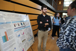 University of Mary Washington junior Mohammad Ali Hassan explains his work investigating the effects of immunogenic chemotherapy on triple-negative breast cancer during the sixth annual Network for Undergraduate Research in Virginia Conference. Hosted by the University of Mary Washington on Saturday, Nov.1, the daylong event welcomed student researchers from across the Commonwealth. Photo by Suzanne Carr Rossi.