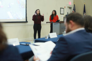 Photo of two students delivering a presentation during the Fall 2025 College of Business Case Competition