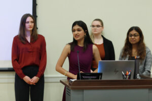 Photo of four UMW students delivering a presentation at the Fall 2025 College of Business Case Competition