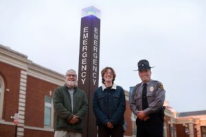 Photo of UMW Professor of Biological Sciences Alan Griffith (left), junior environmental science major Jillian Rosenquist (center), and Chief of Police Michael Hall (right) teamed up to map blue light phones across UMW and enhance campus safety—a project that paved the way for an internship on Capitol Hill for Rosenquist.