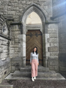 A student standing in front of an old cathedral.