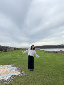 A student standing in front of an Irish military fortress.