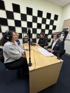 UMW President Troy Paino seated around the table with students Adam McAninley ’27, Amira Said ’26 and Matthew Clinton '26.