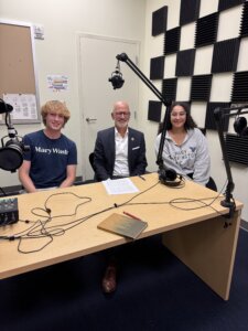 Student leaders Adam McAninley ’27 and Amira Said ’26 seated at a table with UMW President Paino.