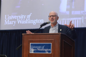 President Troy Paino speaking at a podium.