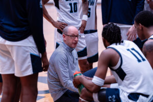 Photo of Coach Marcus Kahn talking to the team
