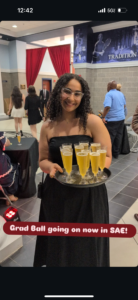 Amira Said serves champagne during Grad Ball at UMW's Anderson Center. An environmental sciences major, Said took her time finding a major that fit her passions and plans for the future.