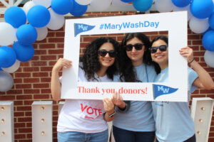 Three students wearing sunglasses taking a photobooth photo with #MaryWashDay and Thank You donors! on it.