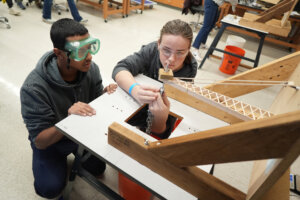 Zain Mirza, 17 (left), and Caden Erickson, 15, of Lake Braddock High School in Fairfax set up their entry during the Virginia Science Olympiad held at UMW on Saturday. Photo by Suzanne Carr Rossi.