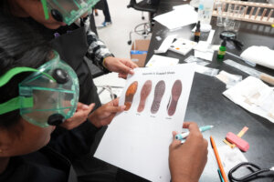 The soles of suspects' shoes were among clues competitors sorted through during a forensics competition at the Virginia Science Olympiad at the University of Mary Washington. Photo by Suzanne Carr Rossi.