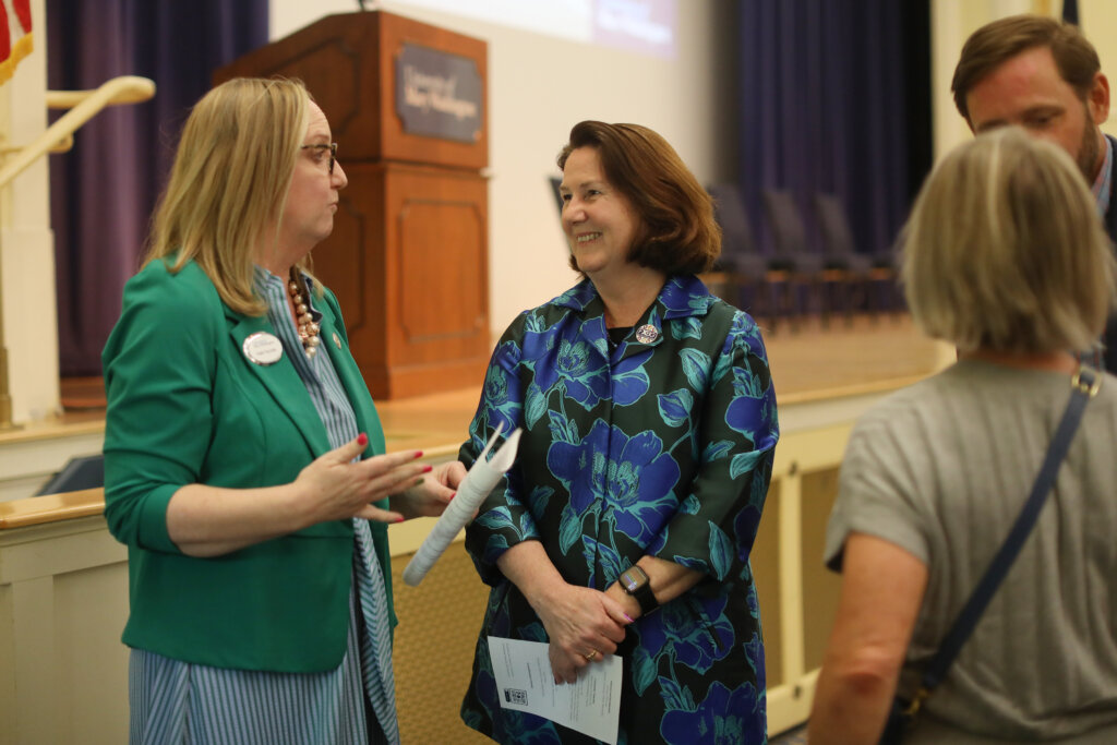 A photo of two women talking to each other