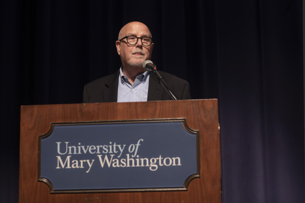 A man speaks at a podium