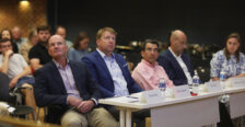 Four men and one woman sit at a judges table