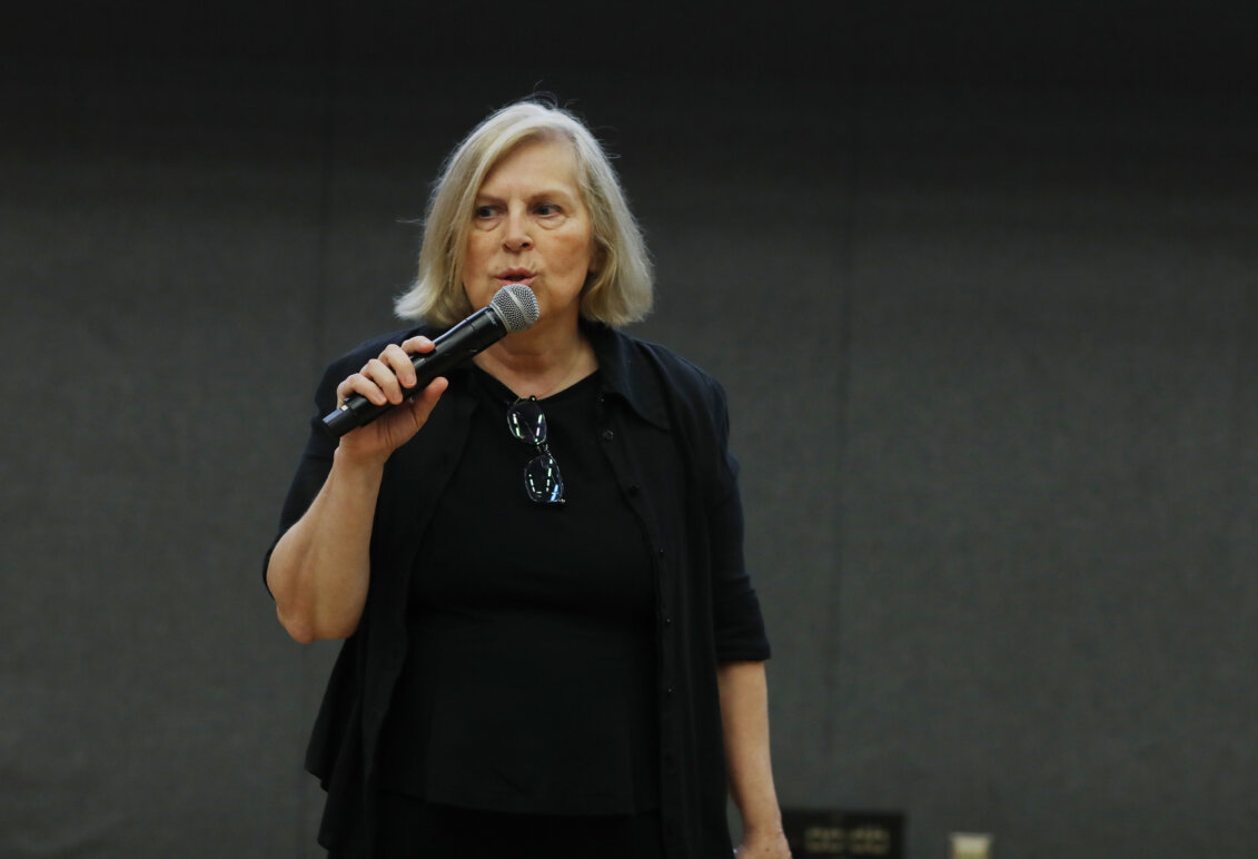 A woman speaks into a microphone