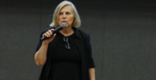 A woman speaks into a microphone