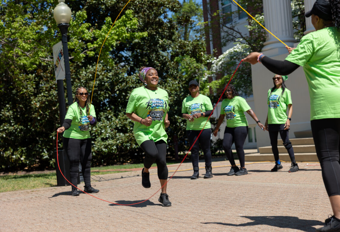 Jump ropers dressed in green perform