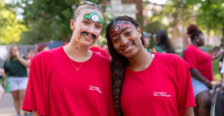 two girls dressed in red and wearing face paintings