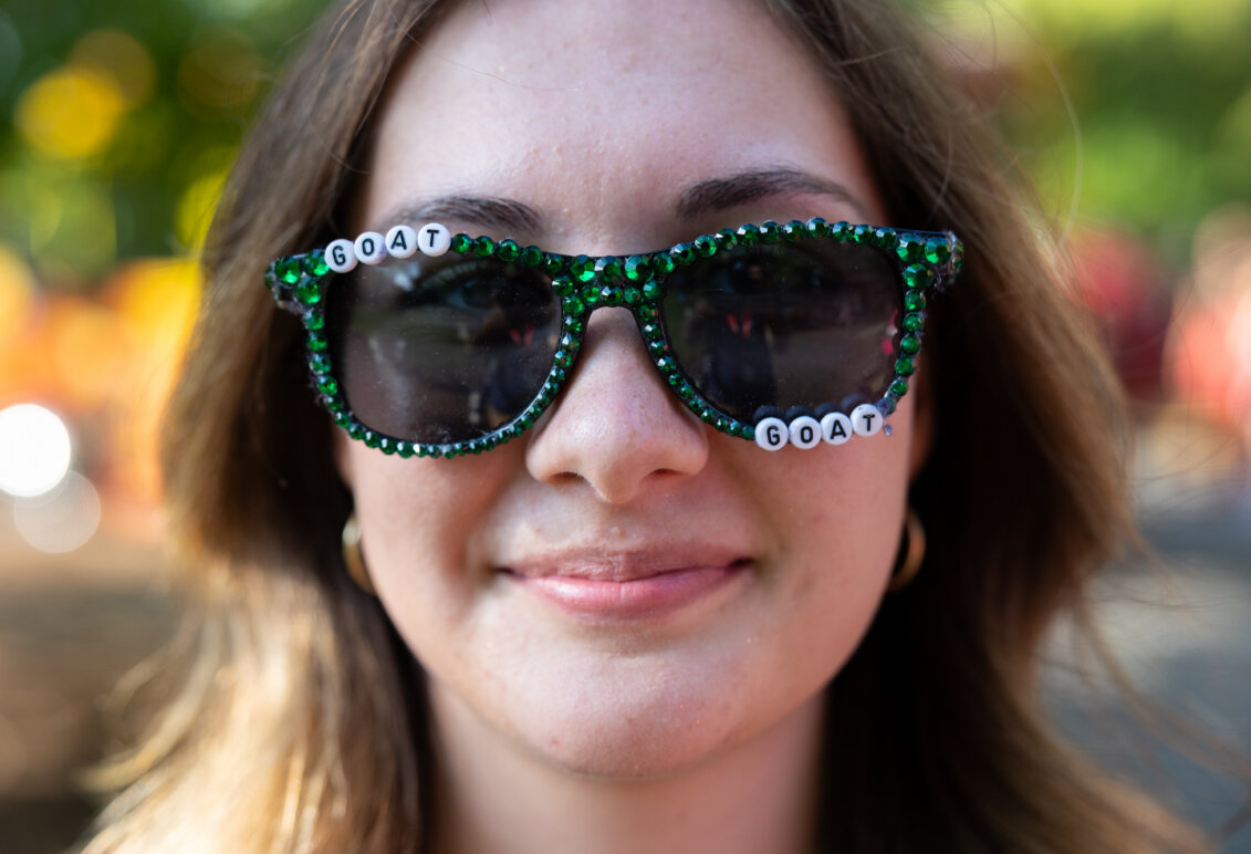 a close-up of a girl wearing glasses with the word goat