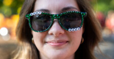 a close-up of a girl wearing glasses with the word goat