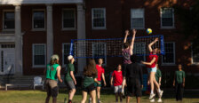 a group of people play volleyball