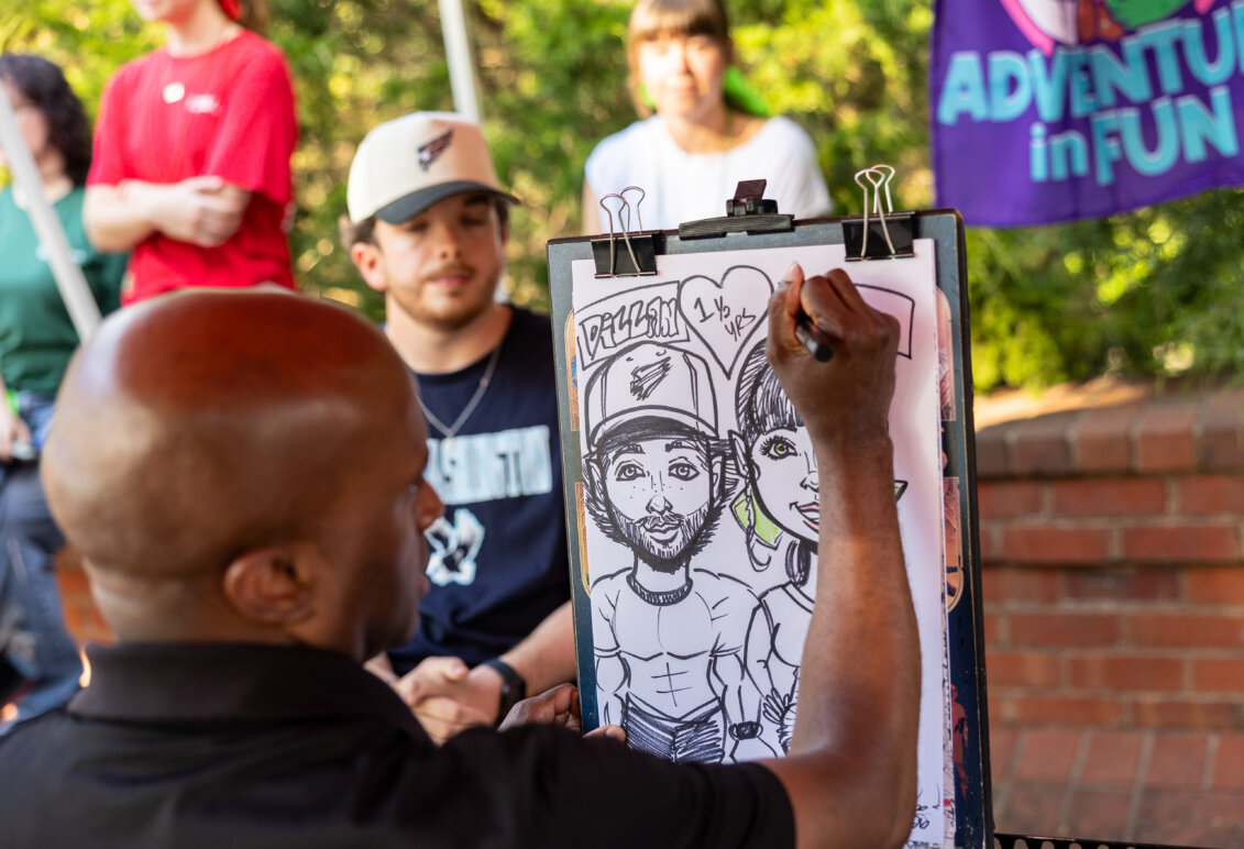 a person draws a caricature of a couple