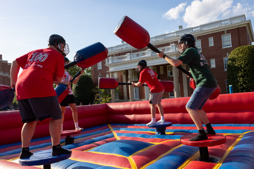 four people joust on an inflatable court